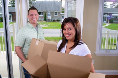 Local movers organising household items for packing