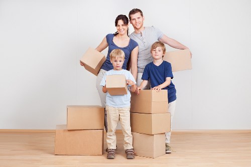 Local removals team handling boxes and furniture in Archway